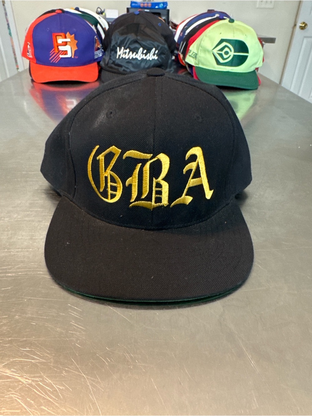 The Classic Black Snapback Hat with Gold BRA Embroidery